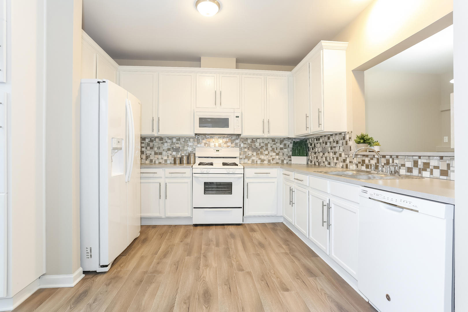 3462 Ravinia Circle Aurora, IL 60504 - Photo 6 of 17 a kitchen with stainless steel appliances white cabinets and a sink