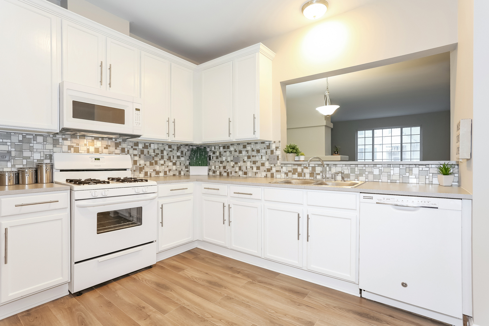 3462 Ravinia Circle Aurora, IL 60504 - Photo 7 of 17 a kitchen with granite countertop white cabinets and white appliances