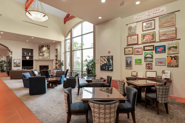 a room with pool table and windows