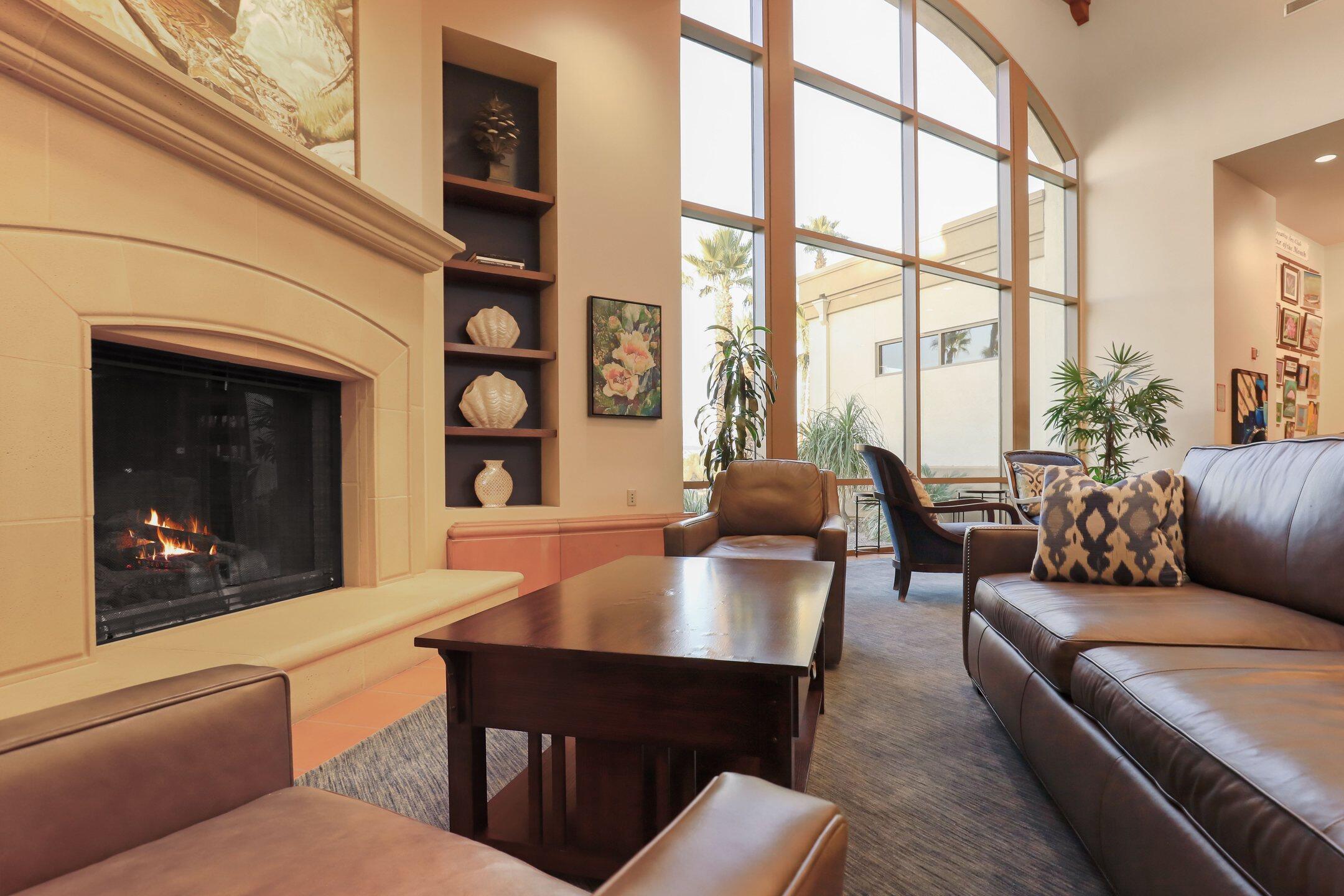 40090 Corte Refugio Indio, CA 92203 - Photo 33 of 50 a living room with furniture a fireplace and floor to ceiling windows