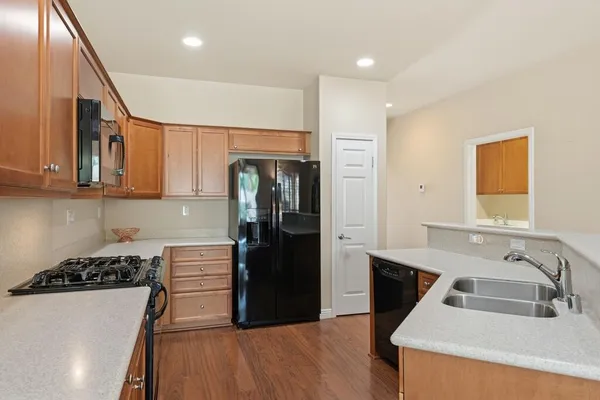 a kitchen with granite countertop a sink and a stove top oven