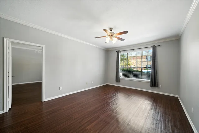 an empty room with wooden floor and window