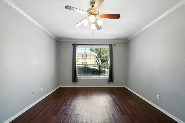 wooden floor in an empty room with a window