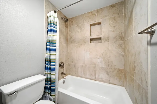 a bathroom with a bathtub and a toilet