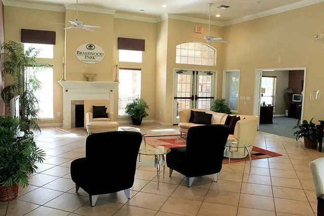 a living room with furniture fireplace and a large window