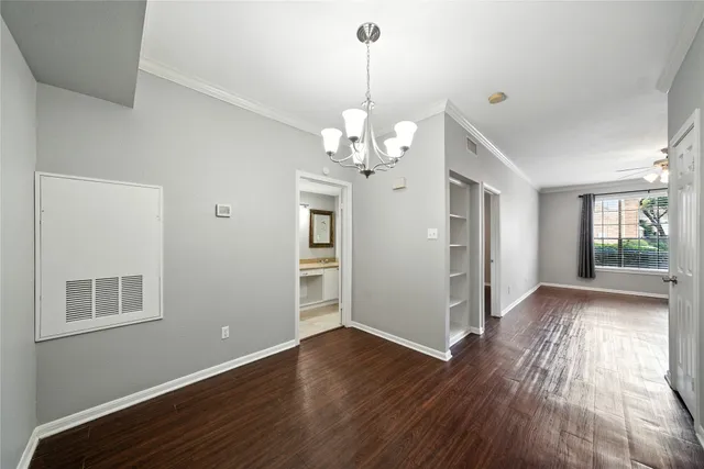 a view of livingroom with chandelier and wooden floor