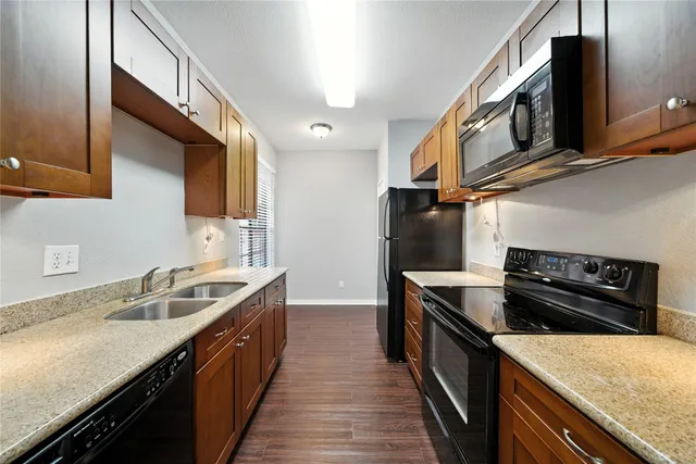 a kitchen with stainless steel appliances granite countertop a sink stove and cabinets