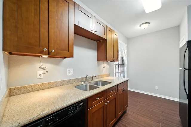 a kitchen with a sink cabinets and wooden floor
