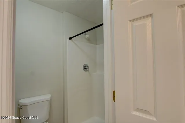 a bathroom with a shower and a toilet