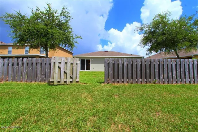 a view of a house with a yard and sitting area