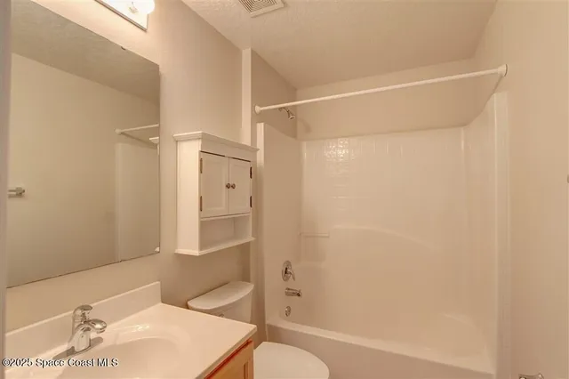a bathroom with a shower and a toilet