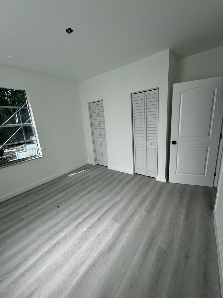 1852 Southwest 22nd Terrace Miami, FL 33145 - Photo 12 of 17 a view of room with wooden floor and window