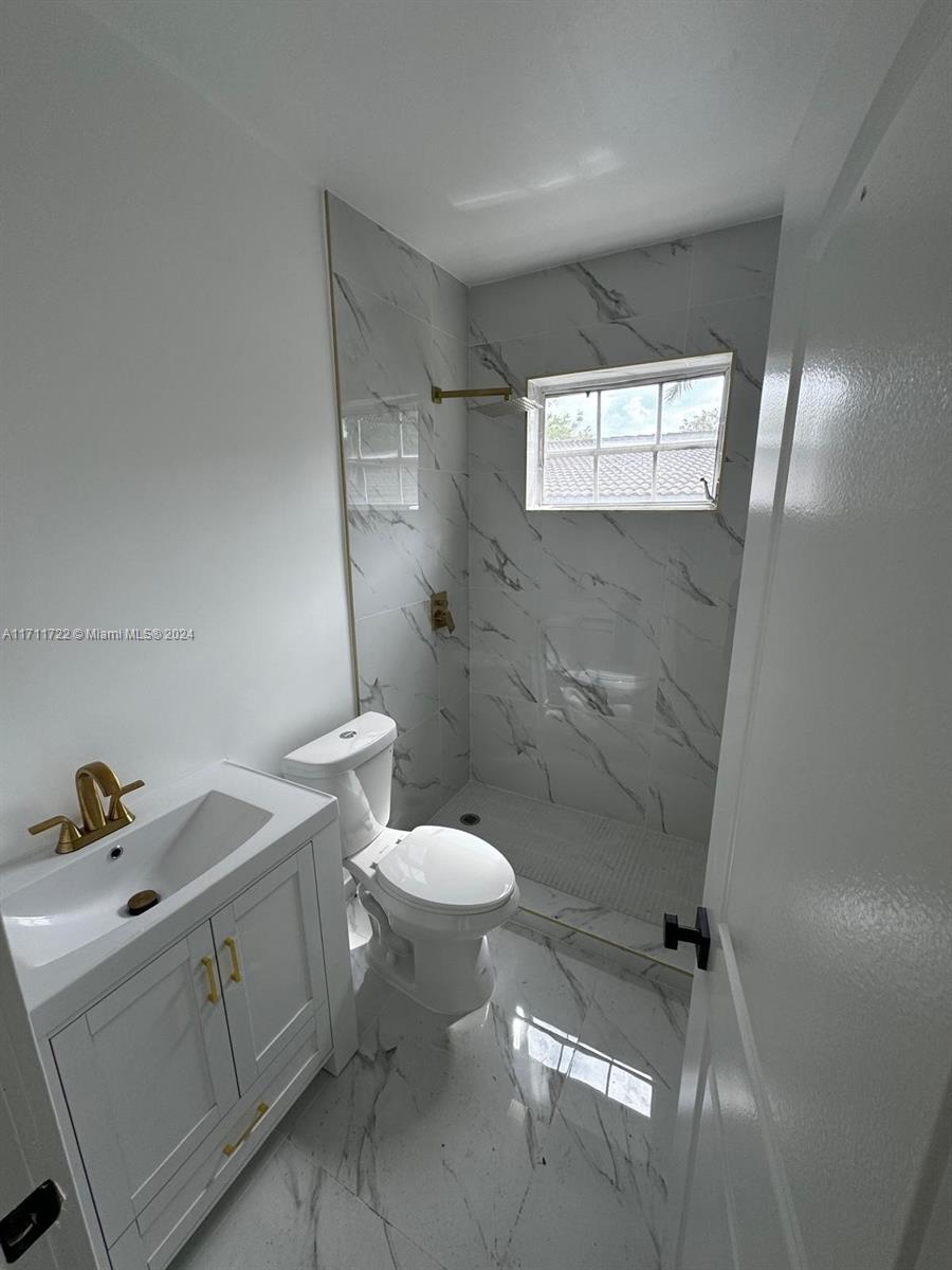 1852 Southwest 22nd Terrace Miami, FL 33145 - Photo 10 of 17 a bathroom with a toilet sink and shower