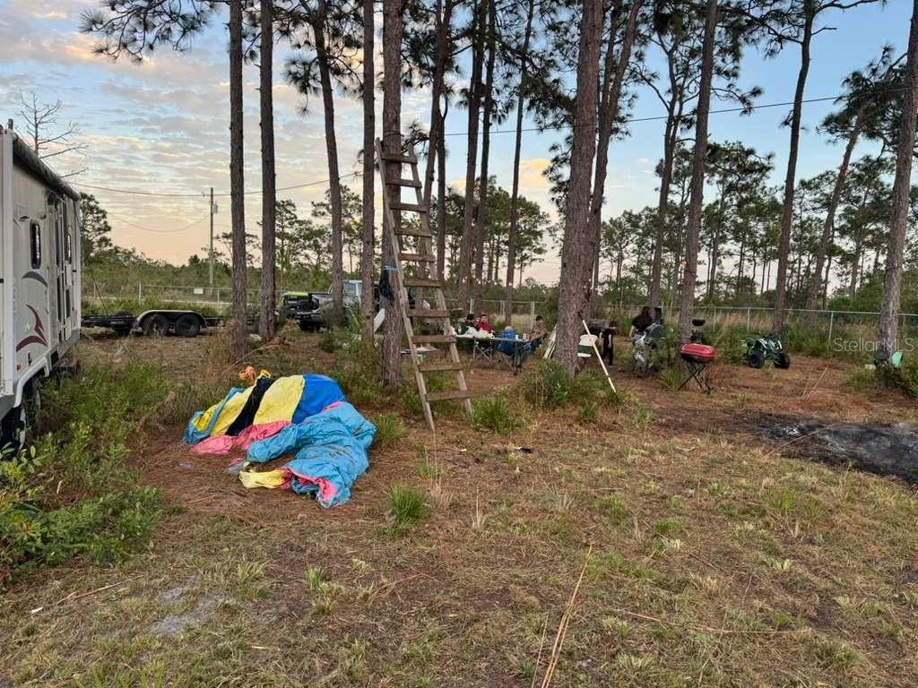 6718 Owens Road St. Cloud, FL 34773 - Photo 9 of 10 an aerial view of a park with large trees