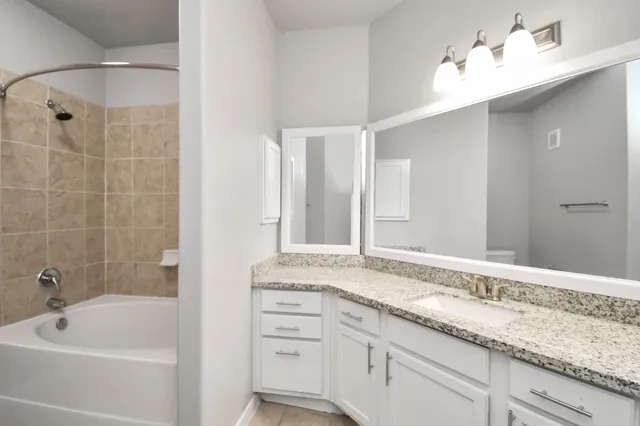 a kitchen with stainless steel appliances granite countertop a sink and a refrigerator