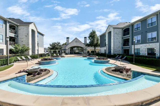 a kitchen with stainless steel appliances granite countertop a refrigerator a stove a microwave and cabinets