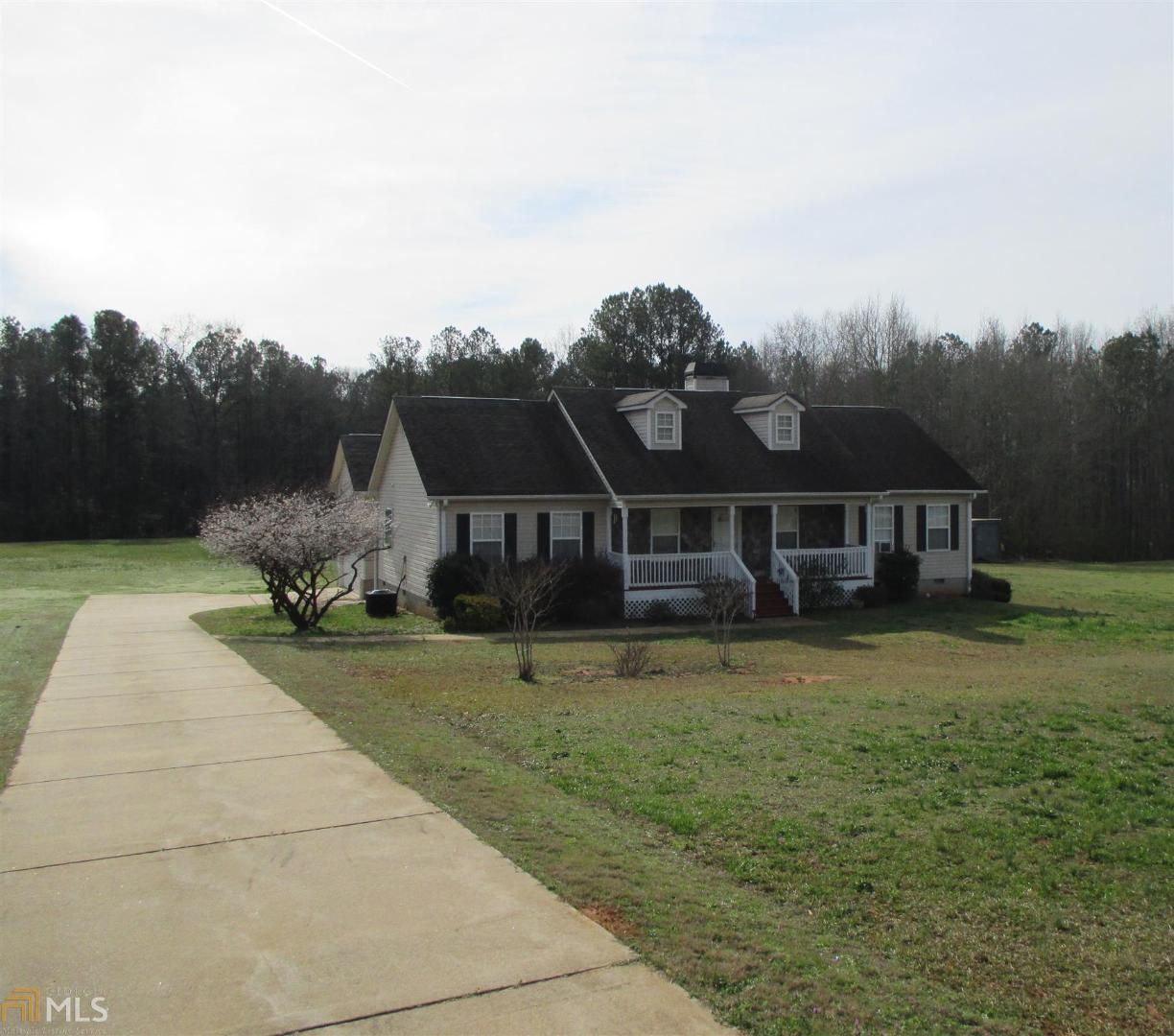 1476 Fincherville Road Jackson, GA 30233 - Photo 1 of 1 a front view of a house with a garden and trees