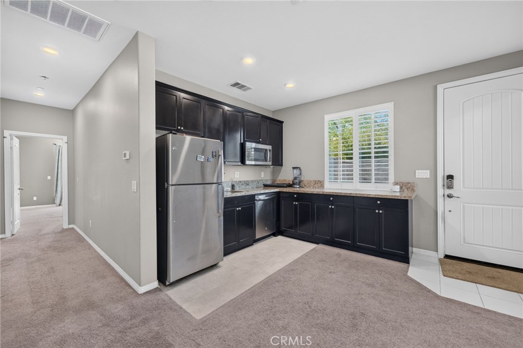 23347 Crystal Way Wildomar, CA 92595 - Photo 41 of 109 a kitchen with stainless steel appliances a refrigerator and a sink