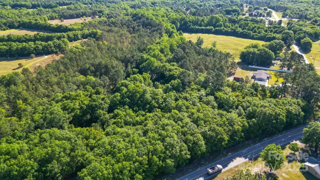 an aerial view of residential house with outdoor space and swimming pool