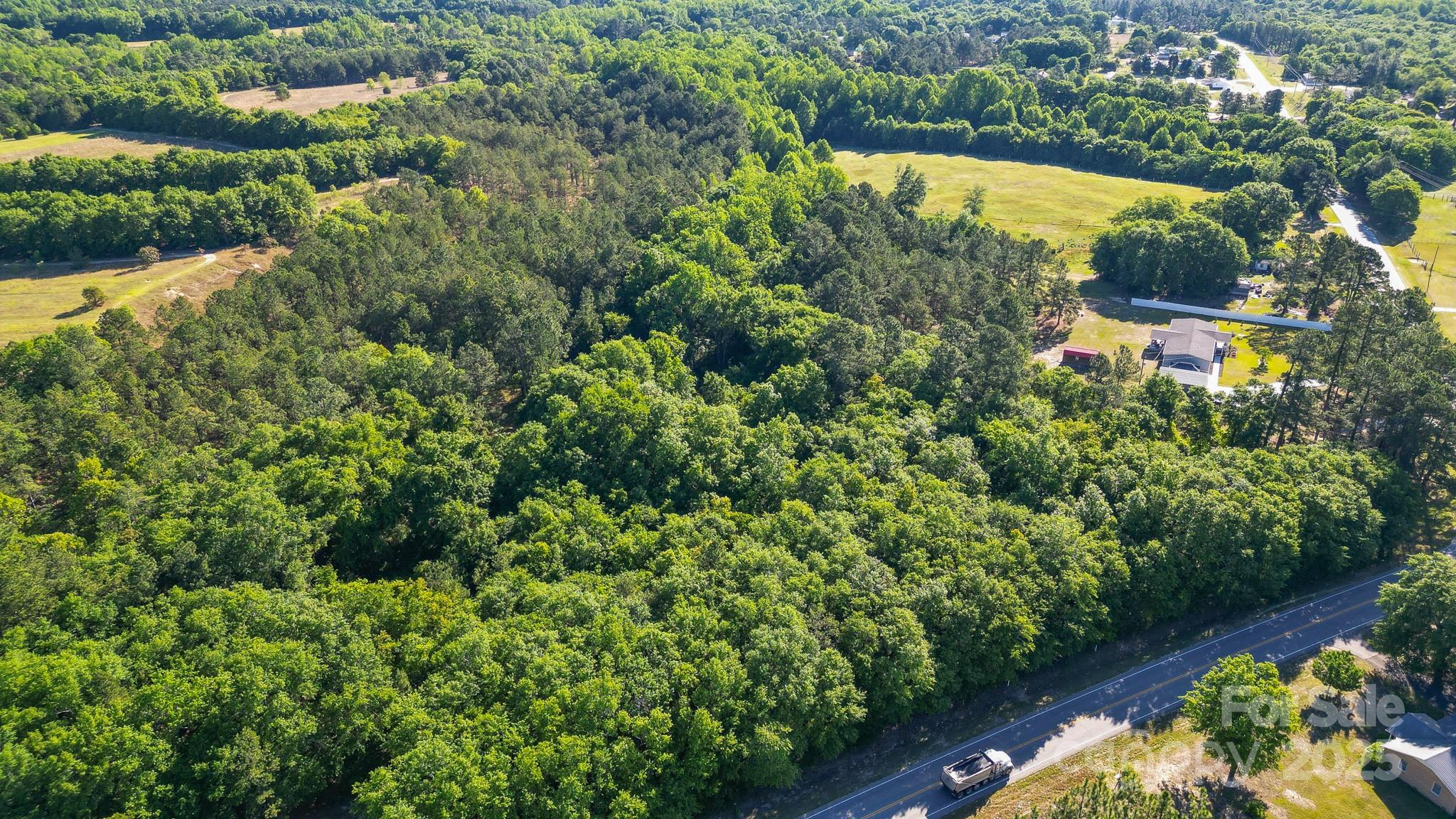 an aerial view of residential house with outdoor space and swimming pool