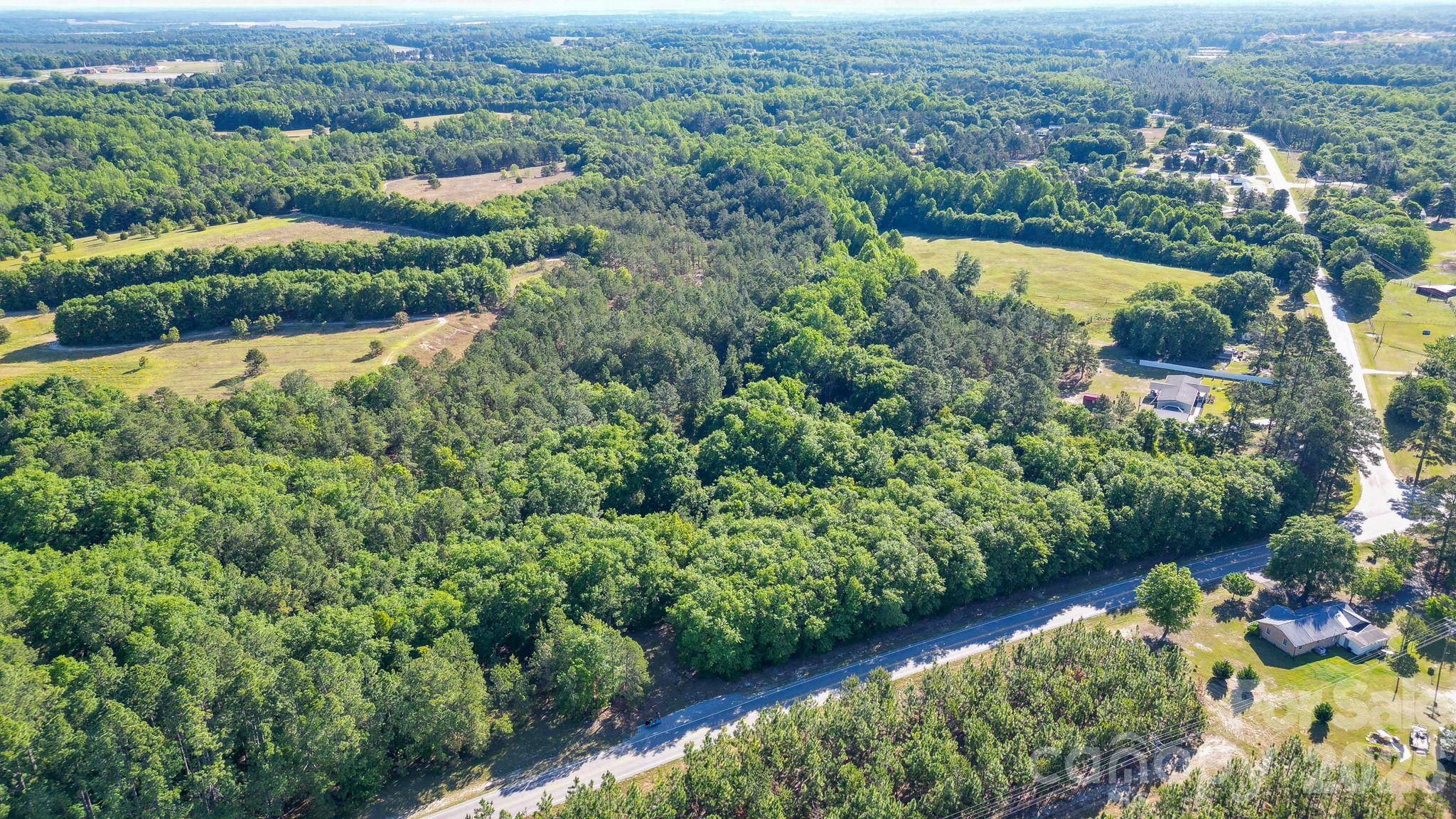 an aerial view of lake residential house with outdoor space and swimming pool