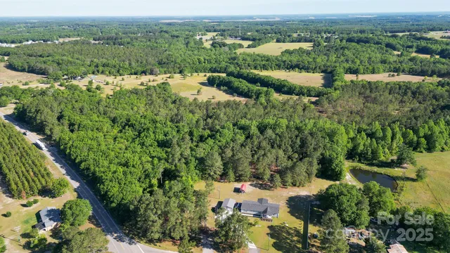 an aerial view of a houses with a yard