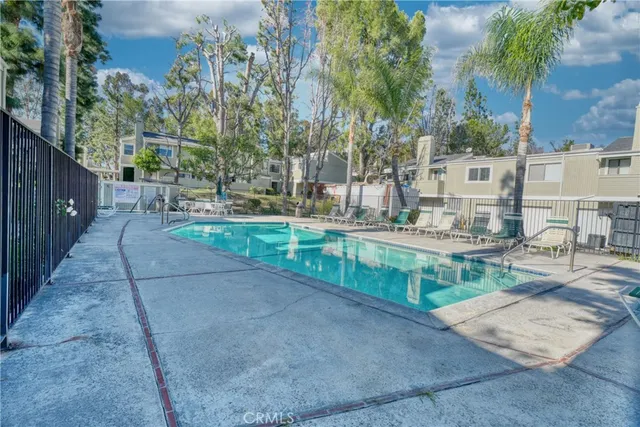 swimming pool view with a outdoor seating