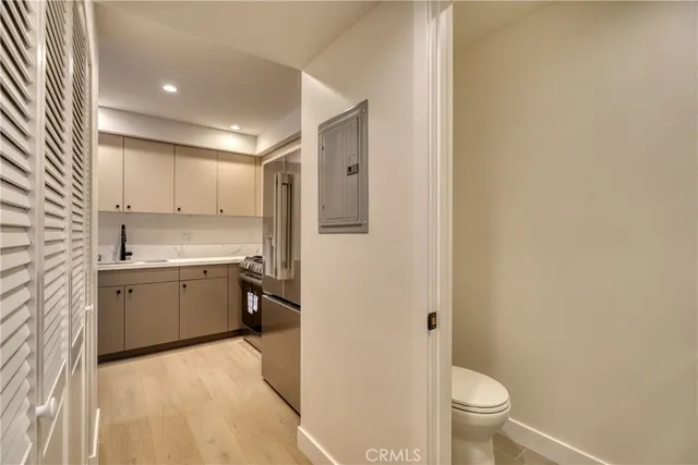 a large bathroom with a granite countertop sink a toilet and a granite counter tops