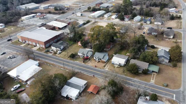 an aerial view of a residential houses with yard