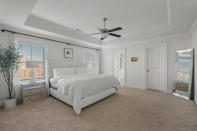 a spacious bedroom with a bed and a window