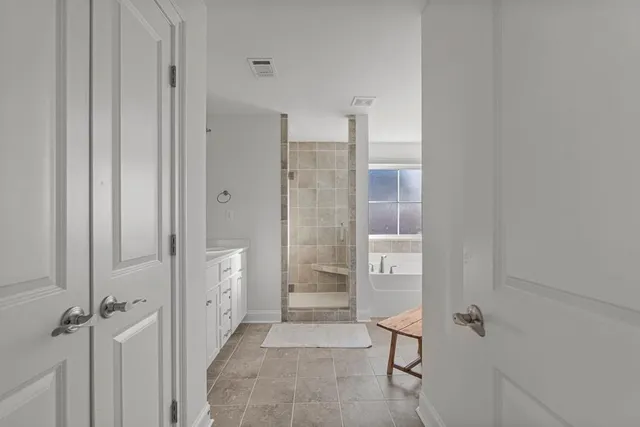 a bathroom with a bathtub and shower