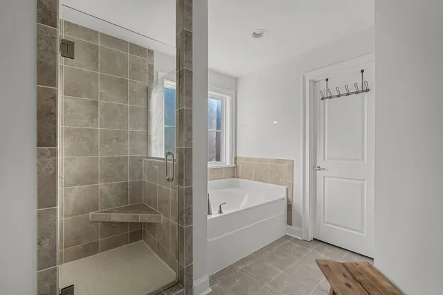 a bathroom with a bathtub and shower