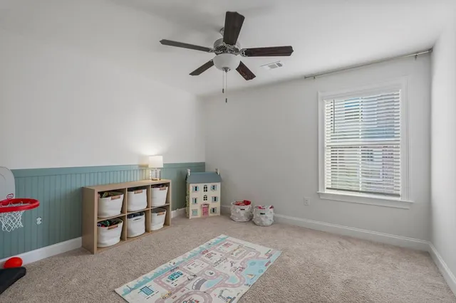 a bedroom with furniture and a window