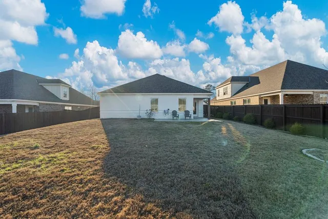 a view of a house with a backyard
