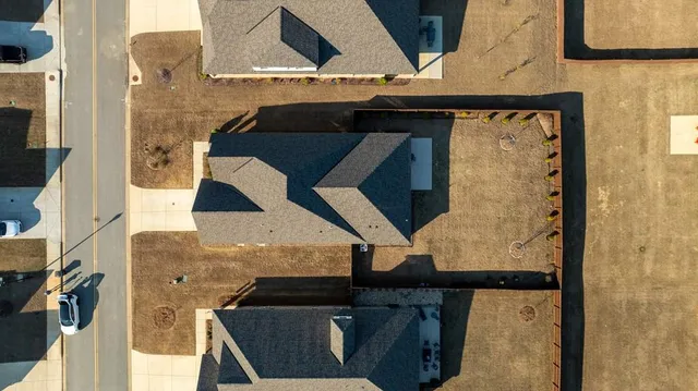 a view of a swimming pool and lounge chairs in the patio