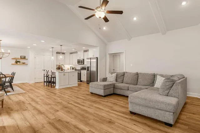 a living room with furniture and kitchen view