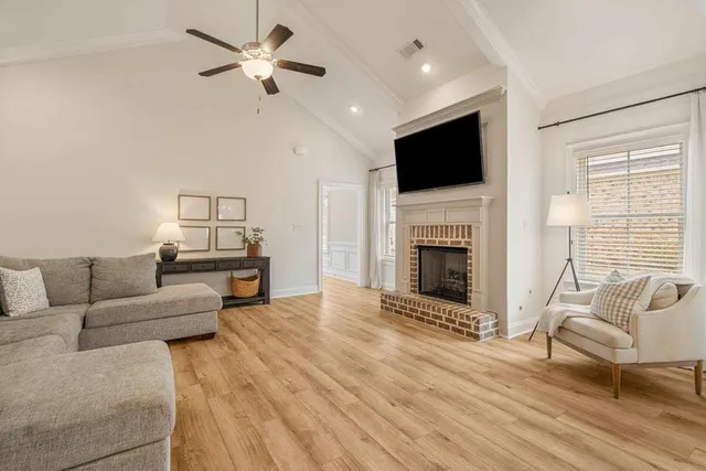 a living room with furniture fireplace and flat screen tv