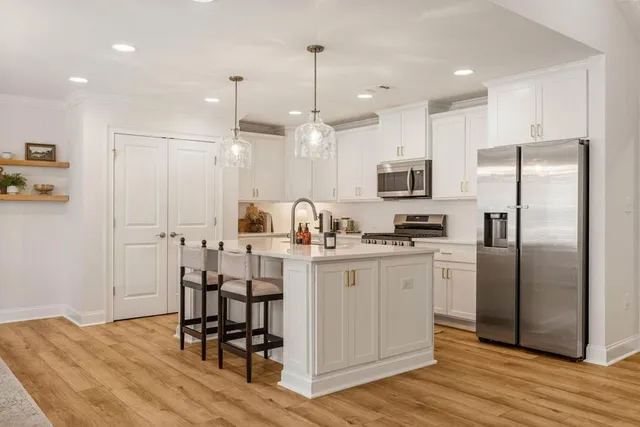 a kitchen with stainless steel appliances a refrigerator stove microwave and cabinets