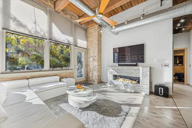a living room with fireplace furniture and a flat screen tv