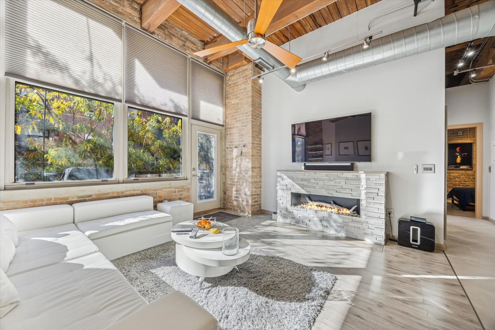 1500 West Monroe Street, Unit 220 Chicago, IL 60607 - Photo 3 of 17 a living room with fireplace furniture and a flat screen tv