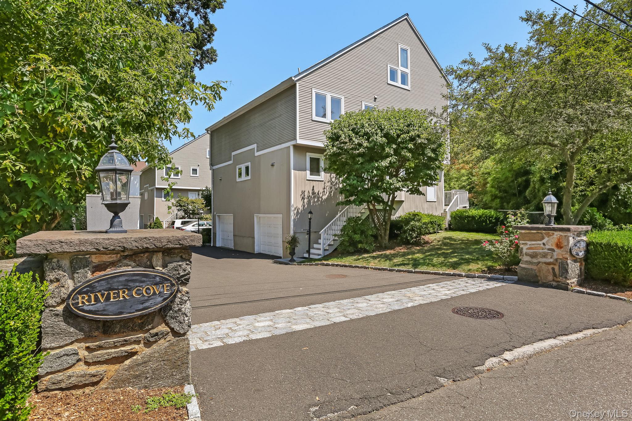 3 River Avenue, Unit 1A Greenwich, CT 06830 - Photo 1 of 1 a front view of a house with a yard