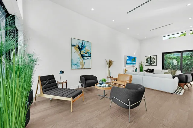 a living room with furniture and a potted plant