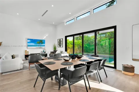a dining room with furniture window and outside view