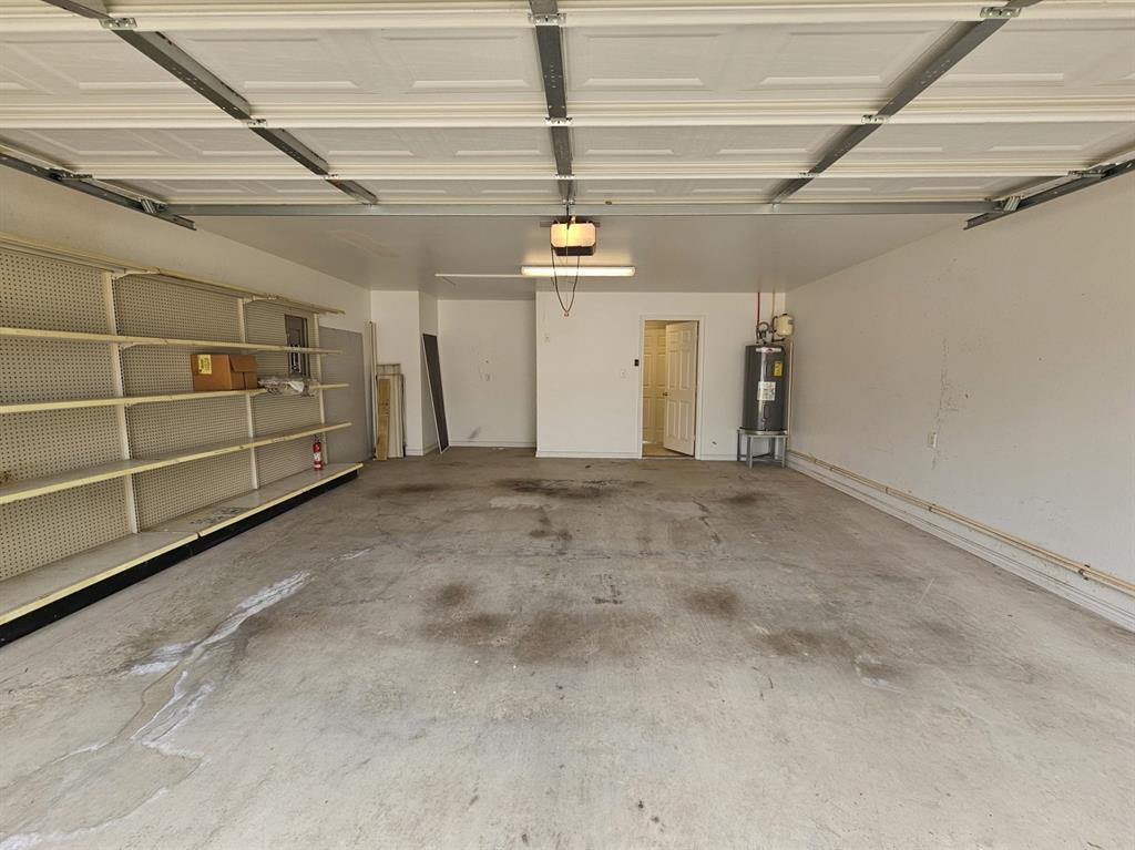 1521 Rice Road, Unit Z101 Tyler, TX 75703 - Photo 24 of 25 Tile flooring, single vanity with integrated sink, built-in shower, window with blinds, and wall-mounted cabinetry