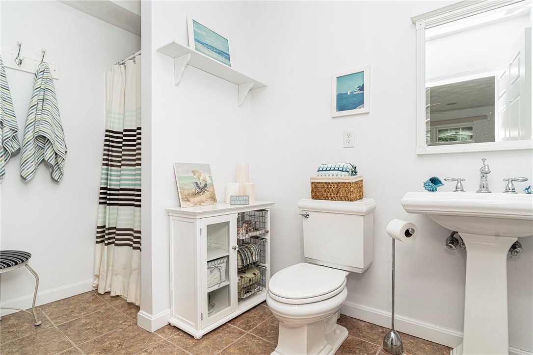 1 Meadow Road Narragansett, RI 02882 - Photo 32 of 50 1st floor bath with shower and tile floor. Come home from the beach, rinse off and relax in the sunroom!