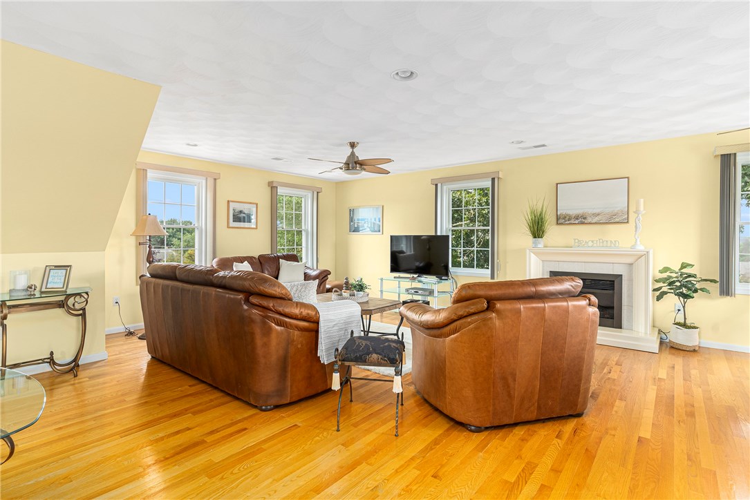 1 Meadow Road Narragansett, RI 02882 - Photo 8 of 50 Notice the amount of windows in the room bringing in lots of natural light. The fireplace is electric and portable...move it anywhere that suits your fancy!