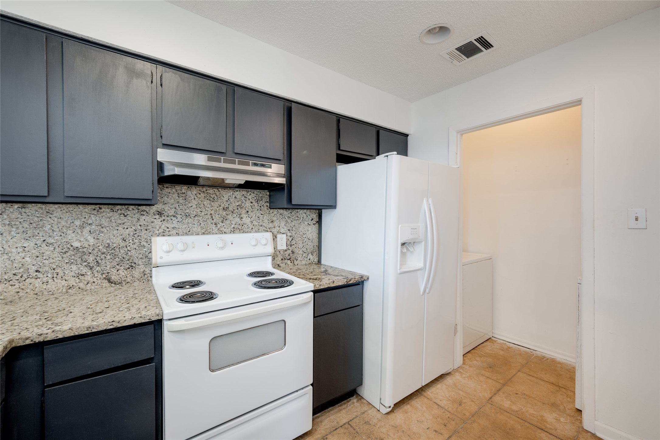 5304 Indio Cove, Unit B Austin, TX 78745 - Photo 11 of 40 a kitchen with a refrigerator sink and cabinets