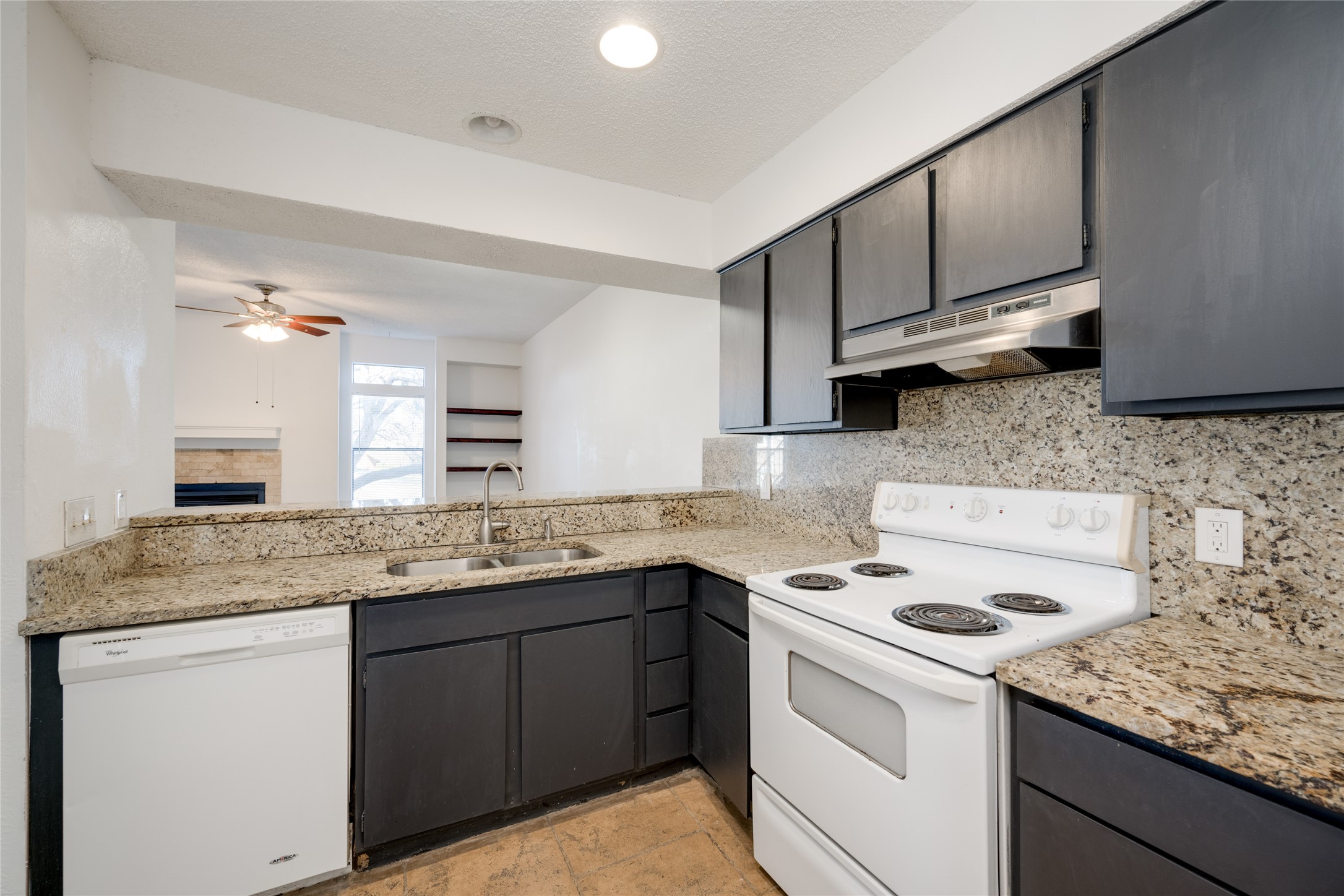 5304 Indio Cove, Unit B Austin, TX 78745 - Photo 13 of 40 a kitchen with cabinets appliances a sink and a counter top space
