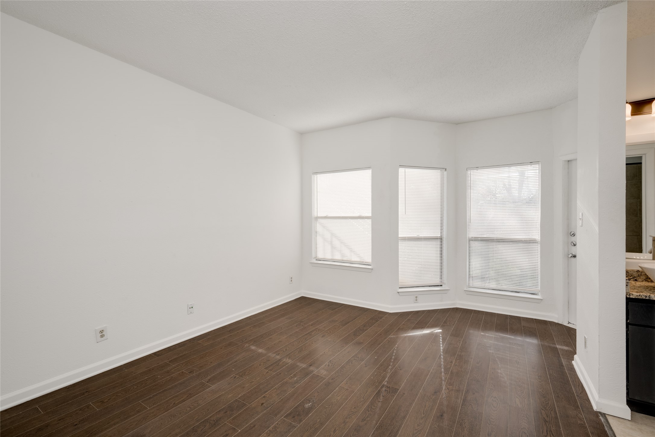 5304 Indio Cove, Unit B Austin, TX 78745 - Photo 14 of 40 an empty room with wooden floor and window