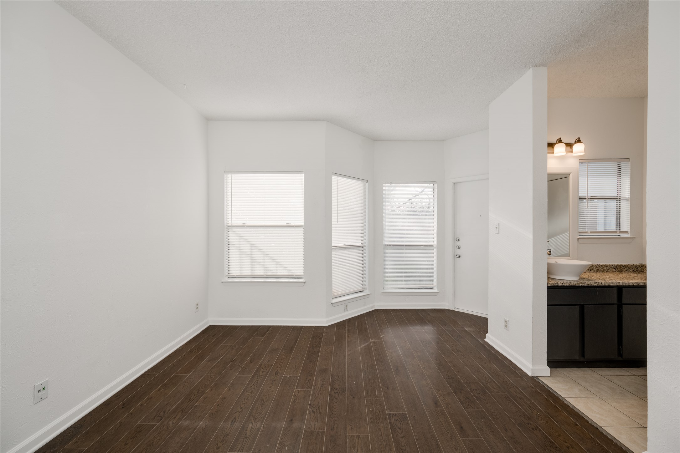 5304 Indio Cove, Unit B Austin, TX 78745 - Photo 15 of 40 an empty room with wooden floor and windows